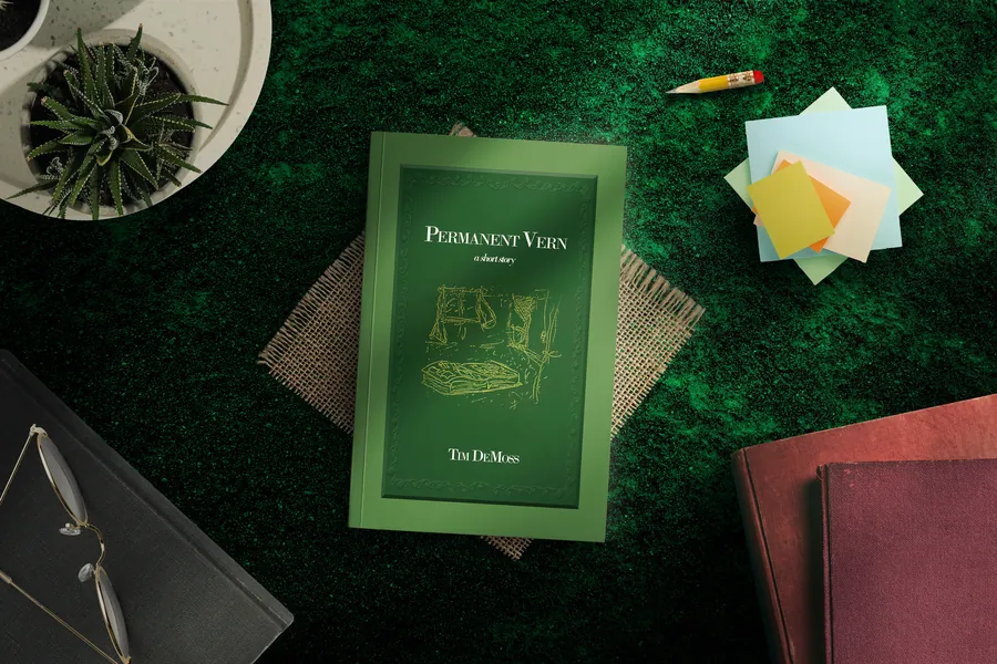 Permanent Vern by Tim DeMoss, green hardcover on a desk